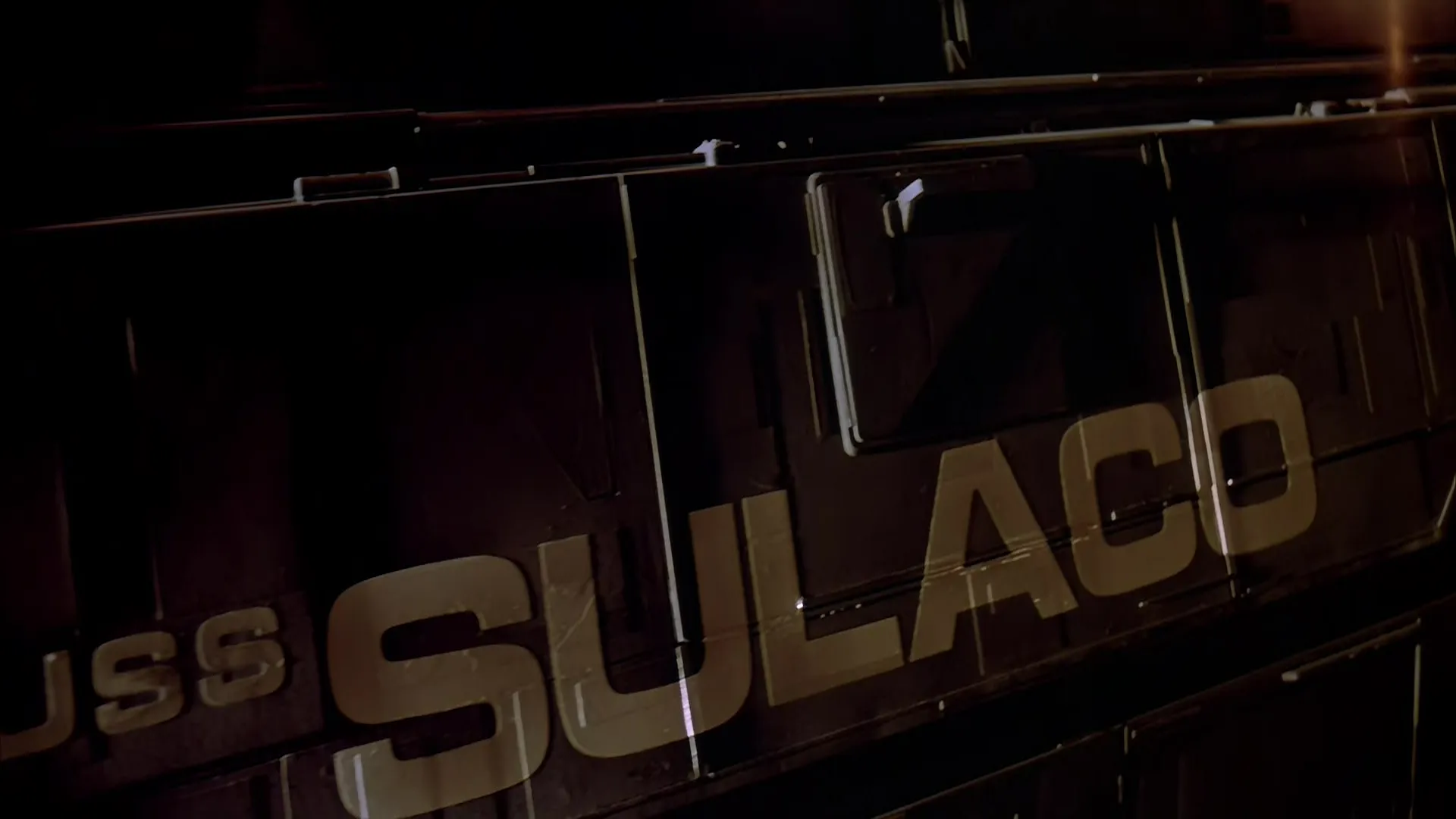 Close view of the USS Sulaco spacecraft hull, its name stenciled in bold letters