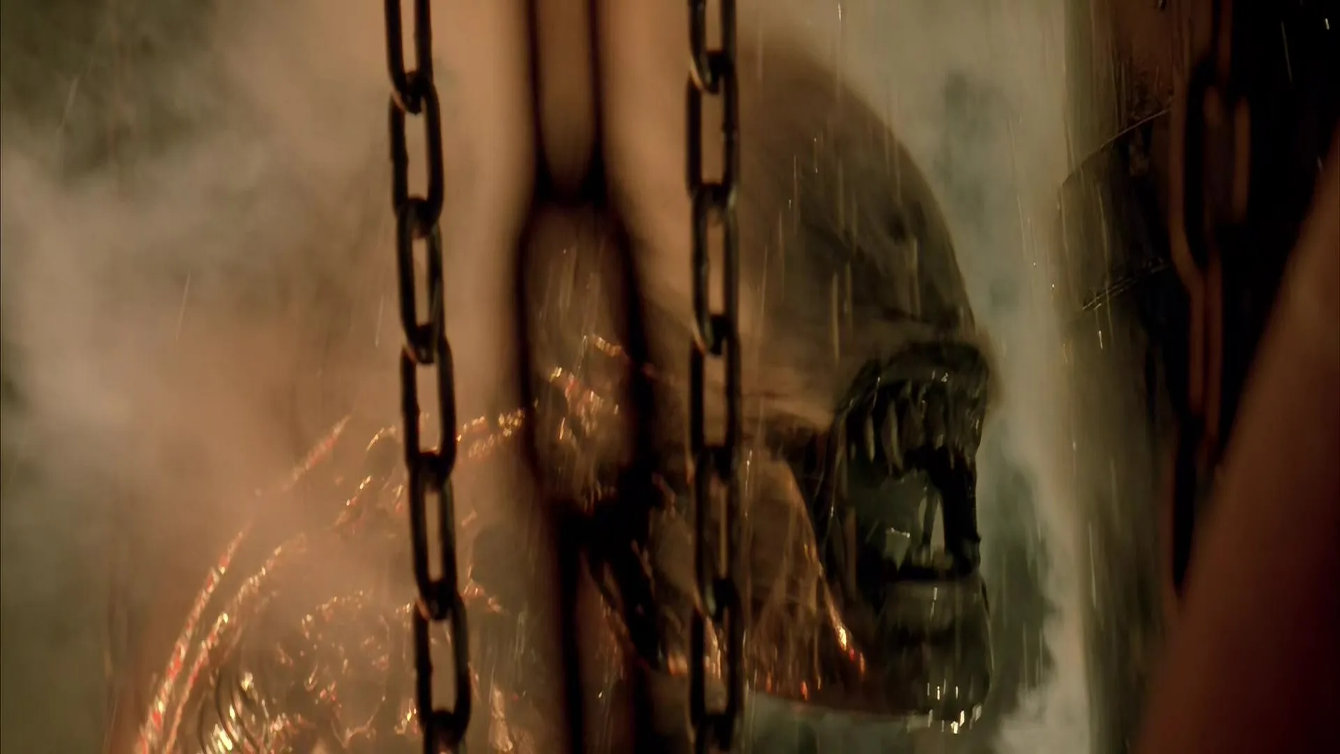 The xenomorph snarls amid steam and dangling chains inside the refinery