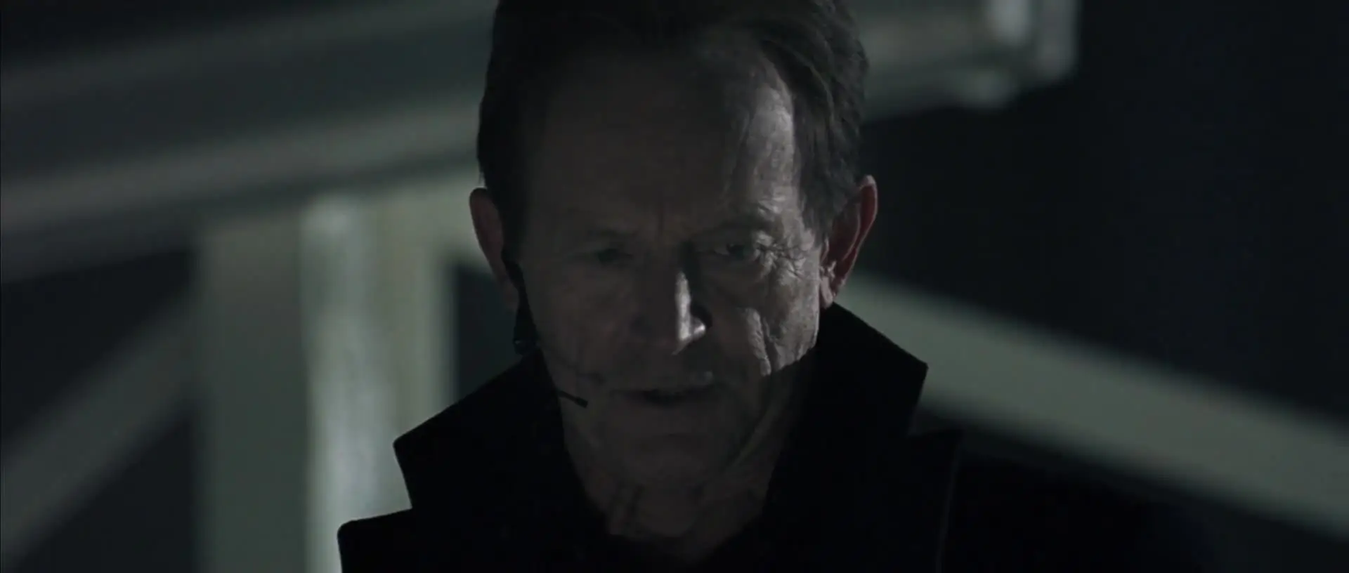 Charles Bishop Weyland, determined, speaking on a headset.