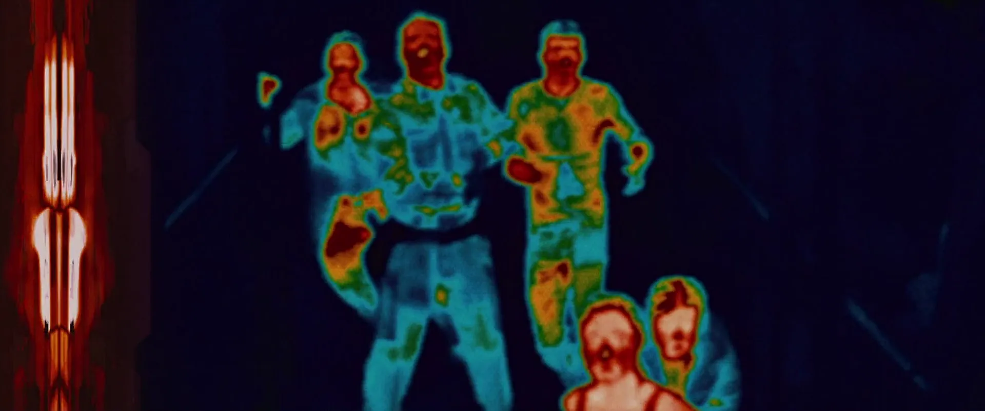 Predator multi‑spectrum view: human heat signatures racing through darkness