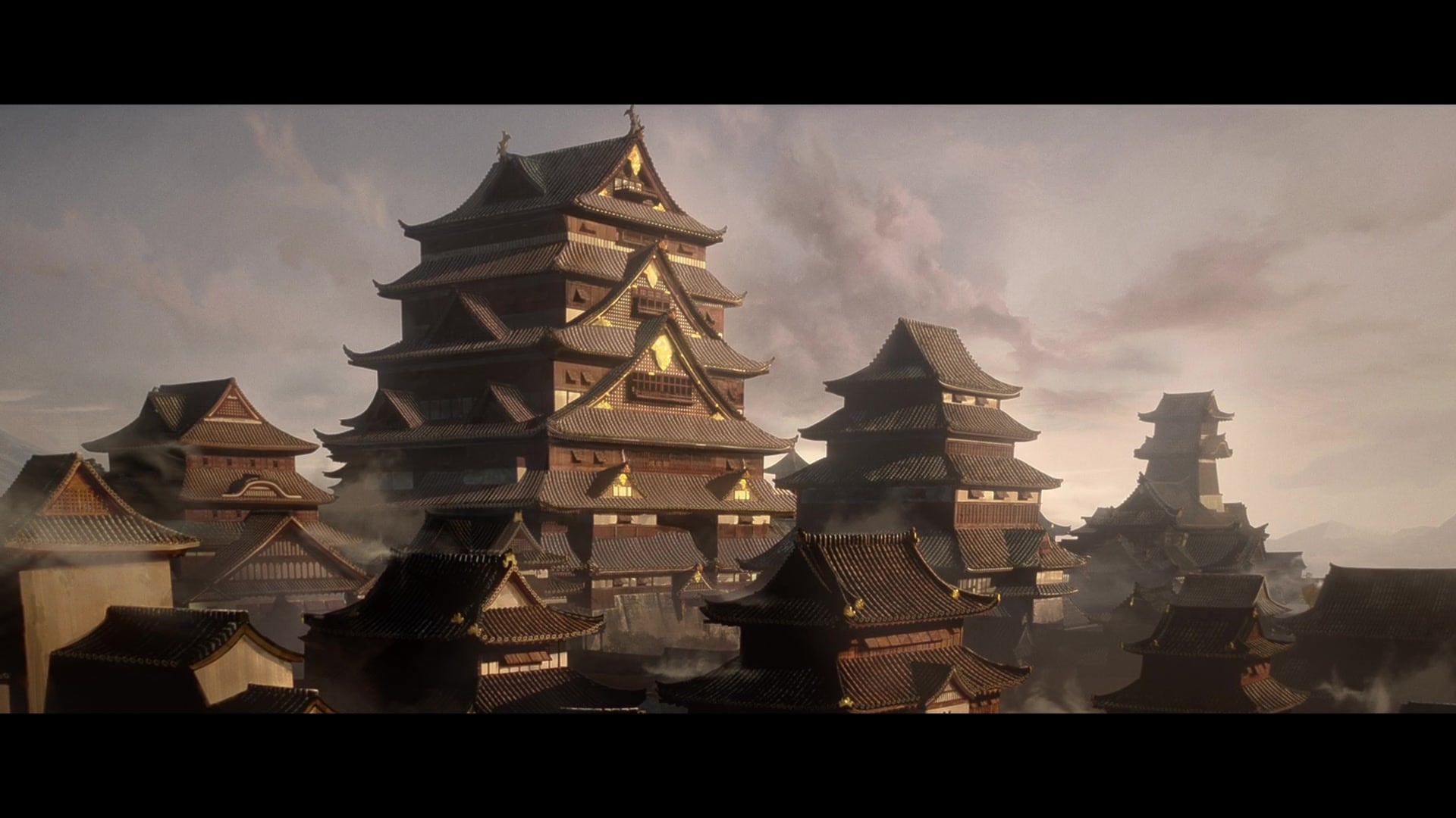 Feudal castle complex at sunrise—layered pagoda roofs and drifting mist