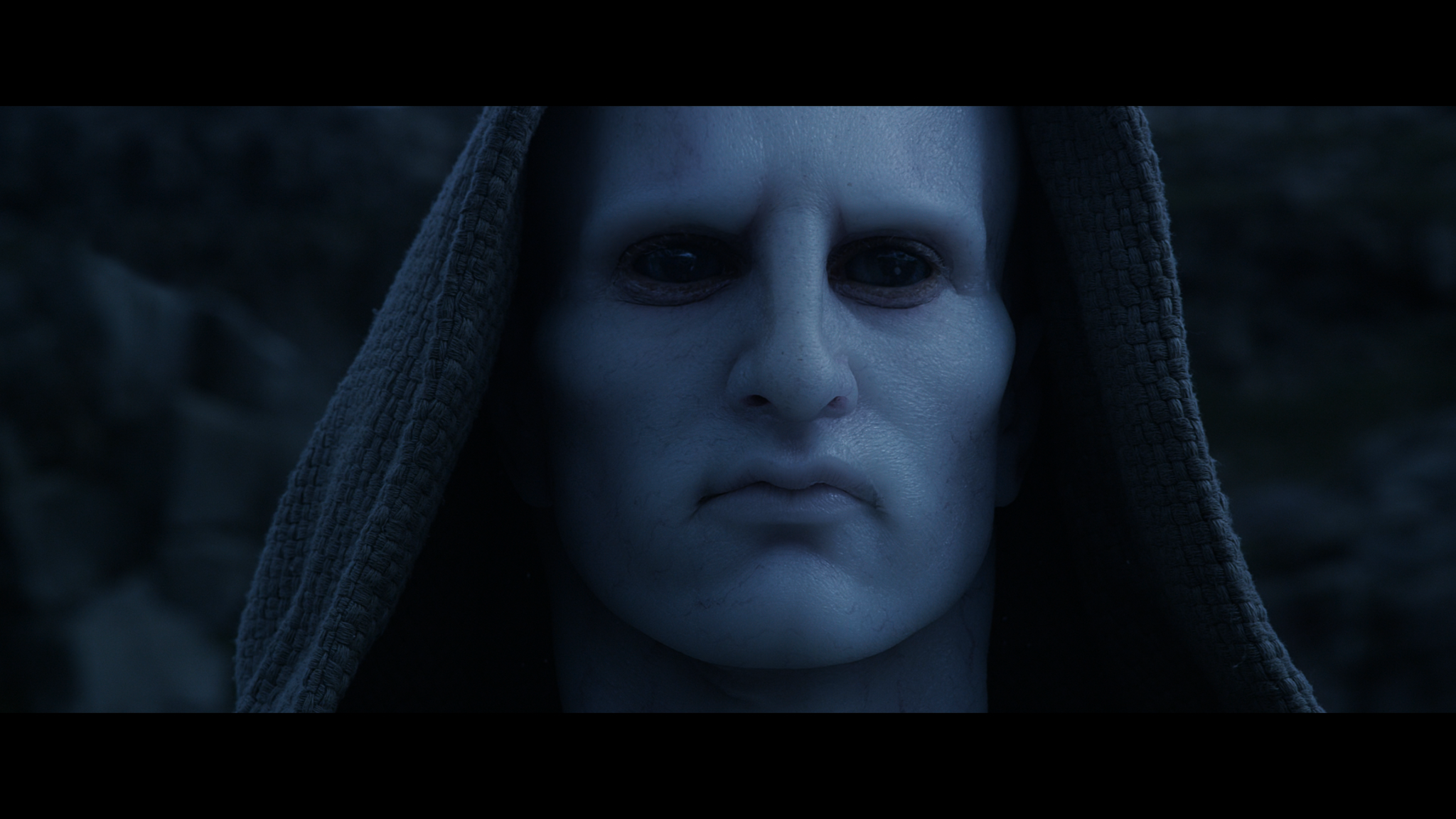Close-up of the pale, black‑eyed Engineer—serene and unreadable